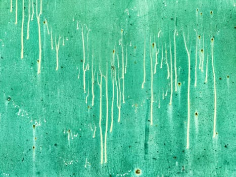 A vibrant turquoise backdrop featuring a unique dripping pattern, providing a perfect space for text or graphic overlays.
