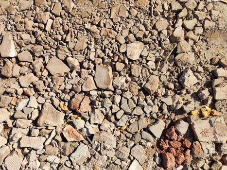 Various sizes and shapes of gravel stones create a textured surface perfect for design projects or backgrounds, taken in a construction zone.