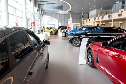 Kazan, Russia - November 25, 2022: Cars in showroom of dealership Kia in Kazan in Russia. Partial focus