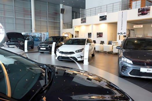 Kazan, Russia - November 25, 2022: Cars in showroom of dealership Kia in Kazan in Russia. Partial focus