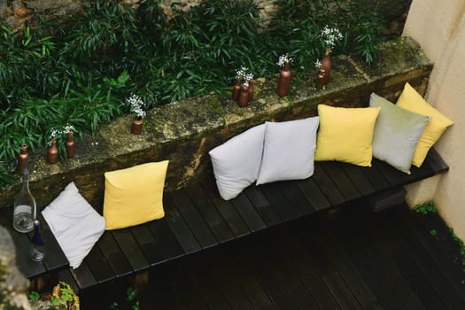 Terrace design with sofa, pillows and flowers and plants. Patio. Garden.