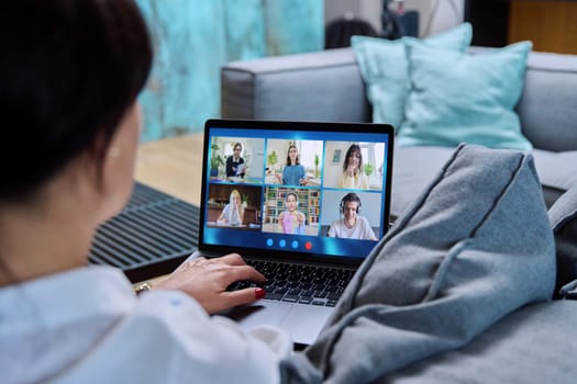 Laptop screen with online video conference by group of teenage students, female teacher in home talking to students. Education, wireless technology, e-learning, virtual lessons, distance learning