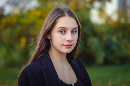 Portrait of a beautiful girl in an autumn park