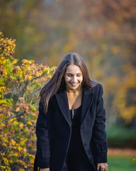 Happy girl spinning in the autumn park