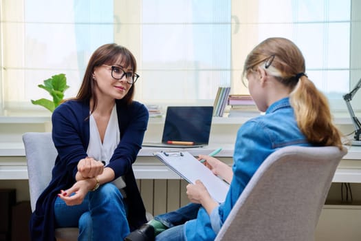 Pre-teen girl at therapy meeting with child psychologist therapist. Mental health of children, problems of adolescence, professional help support from specialist counselor psychotherapist