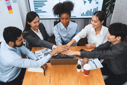 Multiracial office worker's hand stack shows solidarity, teamwork and trust in diverse community. Businesspeople unite for business success through synergy and collaboration by hand stacking. Concord