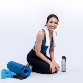 Athletic and sporty asian woman resting after intensive cardio workout training. Healthy exercising and fit body care lifestyle pursuit in studio shot isolated background. Vigorous