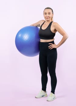 Full body length shot athletic and sporty senior woman with fitness exercising ball on isolated background. Healthy active and body care lifestyle after retirement. Clout