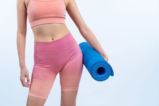 Young attractive asian woman portrait in sportswear with exercising mat. Healthy exercise and workout routine lifestyle concept. Studio shot isolated background. Vigorous