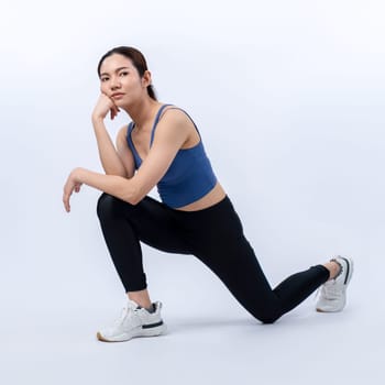 Young attractive asian woman in sportswear stretching before fitness exercise routine. Healthy body care workout with athletic woman warming up on studio shot isolated background. Vigorous