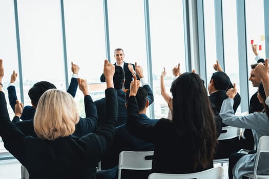 Group of business people meeting in a seminar conference . Audience listening to instructor in employee education training session . Office worker community summit forum with expert speaker . Jivy