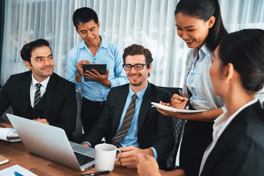 Diverse of business people from various ethnic group working in modern office environment. Productive and multi ethnic office workers engage in discussion for strategic business marketing. Habiliment