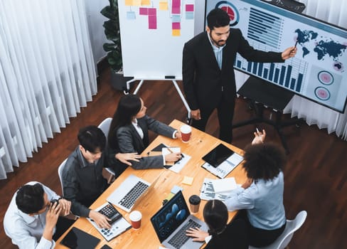 Top view business presentation with data analysis dashboard on TV screen in modern meeting room. Business people brainstorming or working together to plan business marketing strategy. Concord