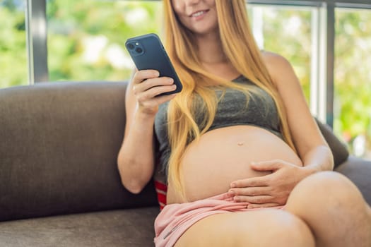 Pregnant girl with a smartphone. The concept of a negative impact on the unborn child in the womb. Violation of the nervous system of the child, reproductive.