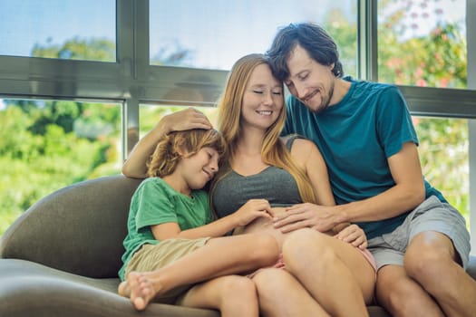 Expectant parents, mom, dad, and their eldest son share a heartwarming moment on the sofa, discussing the exciting journey of pregnancy.