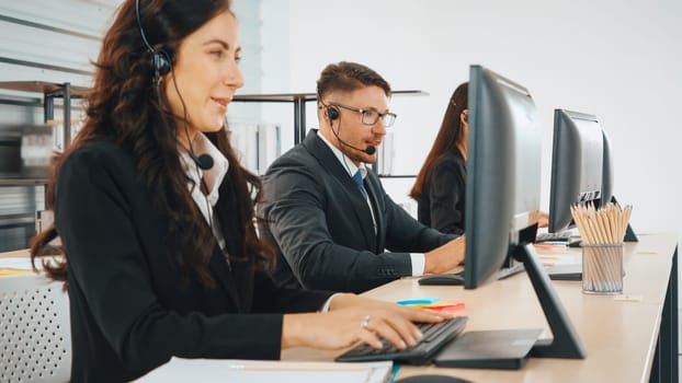 Business people wearing headset working in office to support remote customer or colleague. Call center, telemarketing, customer support agent provide service on telephone video conference call. Jivy