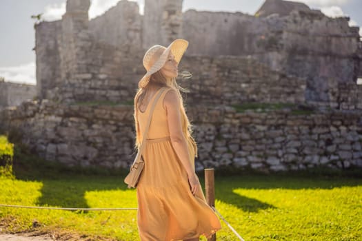 Woman tourist enjoying the view Pre-Columbian Mayan walled city of Tulum, Quintana Roo, Mexico, North America, Tulum, Mexico. El Castillo - castle the Mayan city of Tulum main temple.