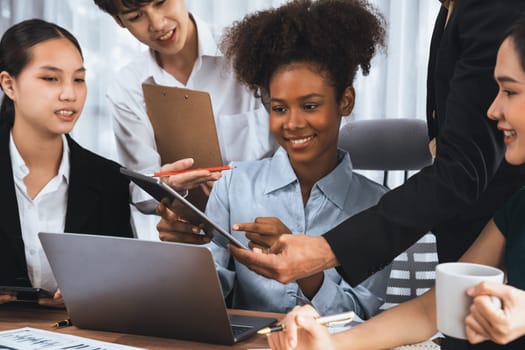 Happy diverse business people work together, discussing in corporate office. Professional and diversity teamwork discuss business plan on desk with laptop. Modern multicultural office worker. Concord