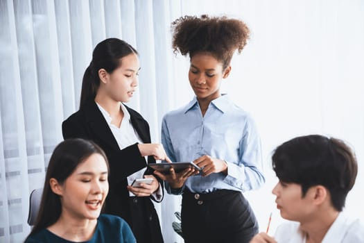 Happy diverse business people work together, discussing in corporate office. Professional and diversity teamwork discuss business plan on desk with laptop. Modern multicultural office worker. Concord