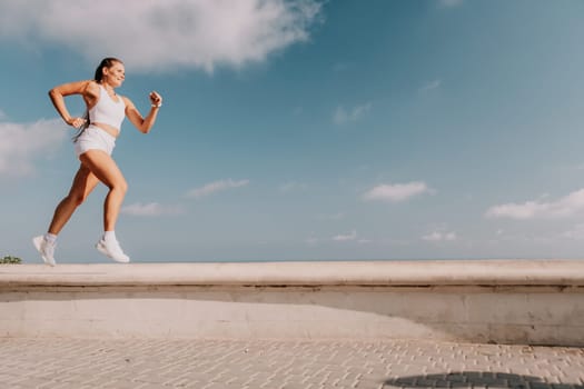 Fitness woman sea. Outdoor workout on yoga mat in park near to ocean beach. Female fitness pilates yoga routine concept. Healthy lifestyle. Happy fit woman exercising with rubber band in park.