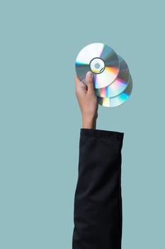 Businessman's hand holding electric CD on isolated background. Eco-business recycle waste policy in corporate responsibility. Reuse, reduce and recycle for sustainability environment. Quaint