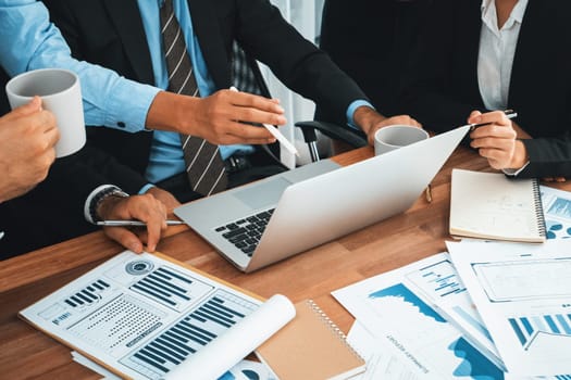 Diverse group of business analyst team analyzing financial data report paper on office table. Chart and graph dashboard by business intelligence analysis for strategic marketing planning Habiliment