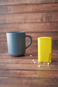 artificial sweetener container on table .