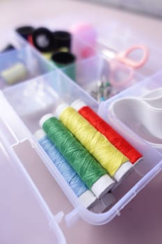 Tools and accessories for sewing on color background .