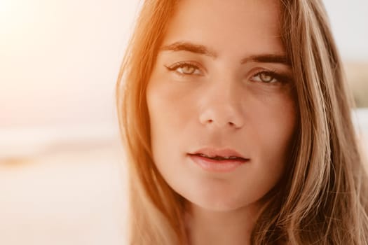 Happy woman portrait in cafe. Boho chic fashion style. Outdoor photo of young happy woman with long hair, sunny weather outdoors sitting in modern cafe