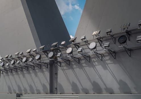 Bangkok, Thailand - 28 Sep, 2024 - Large outdoor LED flood lights spotlights shine for the bridge at night illuminated on Bridge foundation post. Outdoor spotlight for lighting the bridge on foundation pillar abutment of under the Bridge, Space for text, Selective focus.