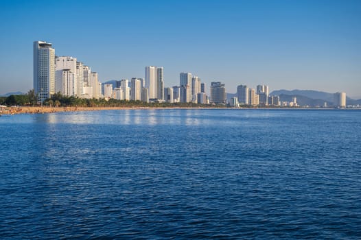 Resort city of Nha Trang in Vietnam with a sandy beach by the sea and skyscrapers of hotels in summer