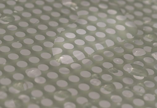 Natural Pattern of dew drops or raindrops on galss background. Detail of Water droplets caused by rain perched on surface of the Glass. Rain water drops on a Glass floor for wallpaper, Poster and Copy space, Selective focus.
