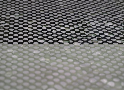 Detail of Water droplets caused by rain perched on surface of the Glass. Rain water drops on a Glass floor, Natural Pattern of dew drops or raindrops on galss background for wallpaper, Poster and Space for text, Selective focus.