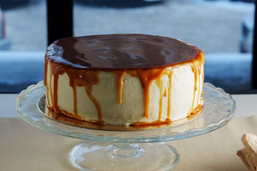 Layers of moist cake are generously topped with smooth caramel, allowing the sweet drizzle to cascade elegantly, inviting everyone to indulge.