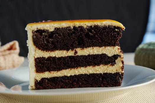 Layers of rich chocolate cake interspersed with velvety cream frosting create a tantalizing dessert experience, perfect for any celebration or indulgence.