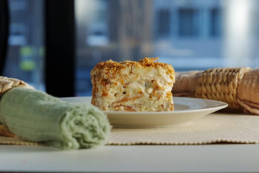 A beautifully crafted dessert roll sits elegantly on a plate, revealing layers of cream and sweet filling, complemented by a lively urban backdrop.