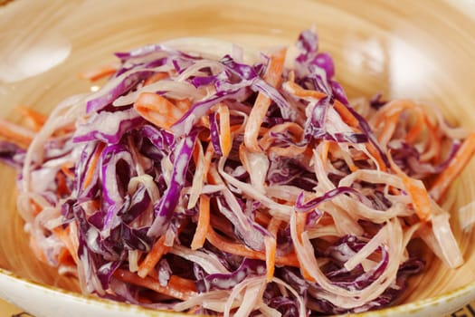 This colorful coleslaw showcases finely shredded purple and orange cabbage, creating a crunchy, refreshing dish