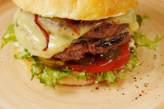 A mouthwatering burger is layered with fresh lettuce, ripe tomatoes, and melted cheese