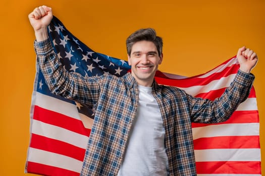 Happy man with national USA flag on yellow background. American patriot, 4th of July - Independence day celebration, election, America, labor. US banner. High quality