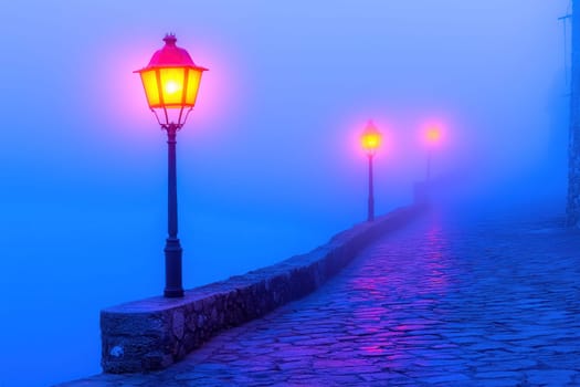 serene village square illuminated by glowing lamps in morning fog.