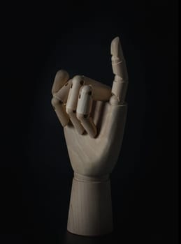 Wooden hand of mannequins showing little finger up sign on dark background. Making promise gesture concept, Wooden hand puppet, Showing, Symbol, Banner design, Gesture and sign, Space for text, Selective focus.
