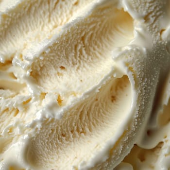 The rich, creamy texture of vanilla ice cream is highlighted in this close-up, showcasing its swirls and smoothness, perfect for summertime enjoyment.