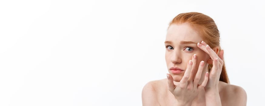 Young caucsian woman squeezes acne on the face of beauty.