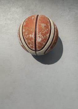 Old basketball ball on cement floor and Natural light. use it as your Wallpaper, Poster and Space for text, Selective focus.