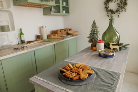 Scandinavian style kitchen decorated in Christmas style, there is a plate of cookies on the table, decor