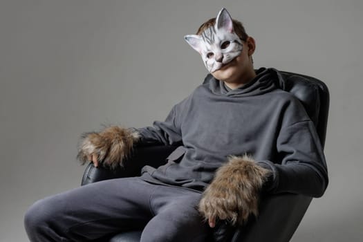 portrait of a teenager quadrobics in a cat mask on a white background, quadrobika subculture imitation of animal actions
