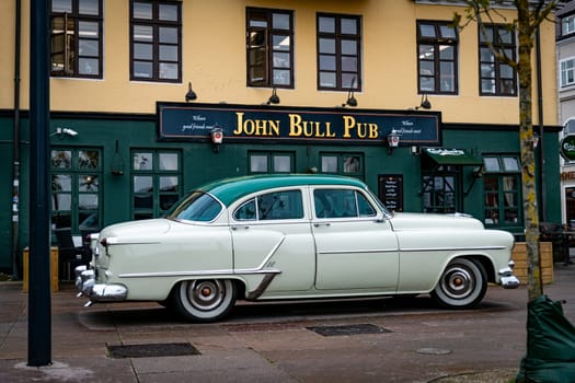Classic Car Parked Outside Historic Pub on City Street in aalborg denmark