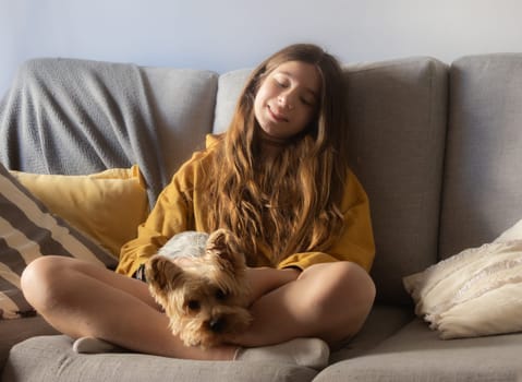 Horizontal photo of a cute girl enjoying with her pet and smiling. Free lifestyle concept. Moments of calm and happiness. Puppy lovers
