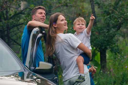 A joyful family is happily spending a beautiful day outdoors, sharing smiles and love amidst a picturesque setting