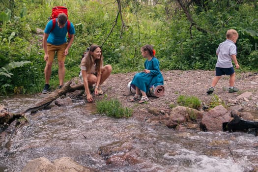 A happy family enjoys a delightful day by the peaceful stream, exploring natures beauty and bonding in joy